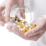 doctor-holding-glass-pills_144627-5136