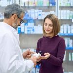 pharmacist-helping-woman-medicine-choice_651396-1235